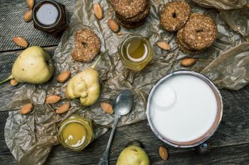 Cookies pears honey and yoghurt on wooden table. Rustic style and autumn food photo