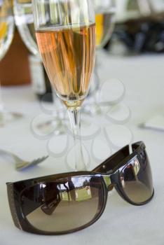 Royalty Free Photo of a Pair of Sunglasses and Glass of Champagne