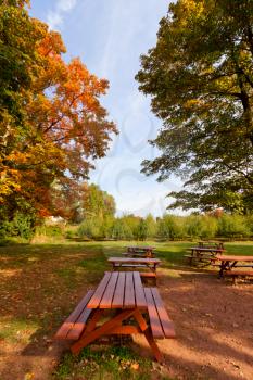 Royalty Free Photo of Autumn Leaves and Picnic Tables