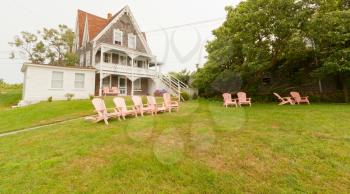 Royalty Free Photo of a Country House With Deck Chair