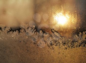 frost and sunlight on winter windowpane