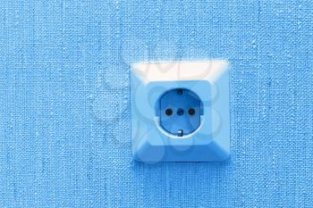 electric socket on wall, blue abstract background
