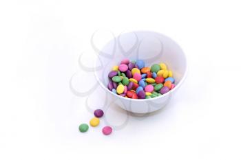 Colorful bright candy in bowl on white