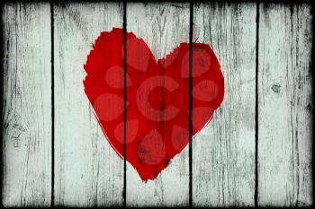 Bright red abstract love symbol on old wooden grunge wall
