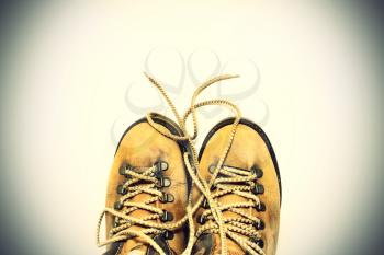 Vintage background yellow shoes with untied shoelaces