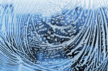 Blue background with pattern of natural soap foam