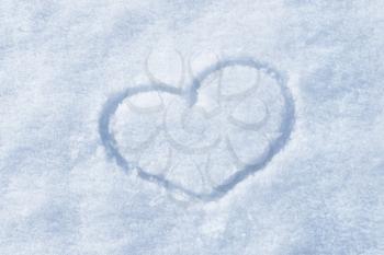 The shape of heart painted on the white snow 