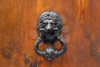 Lion Head Door Knocker on wooden background