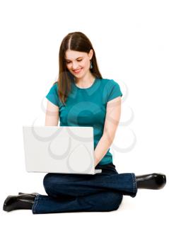 Royalty Free Photo of a Woman on her Laptop Sitting on the Floor
