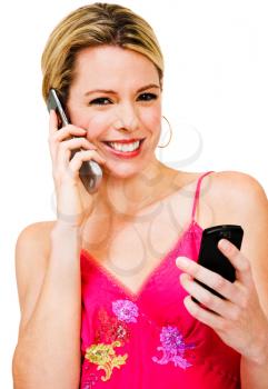 Royalty Free Photo of a Woman Talking on a Mobile Phone and Texting on Another Phone