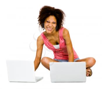 Royalty Free Photo of a Woman Sitting on the Floor Using Two Laptops