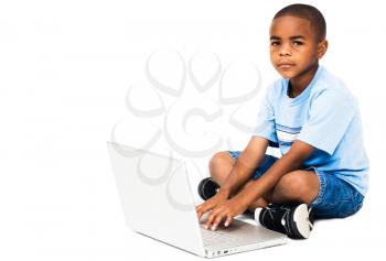 Royalty Free Photo of a Young Boy Using a Laptop