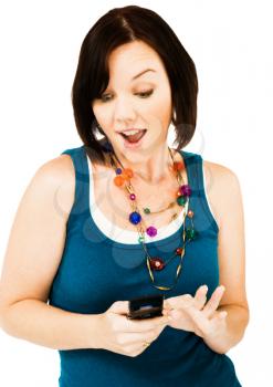 Young woman text messaging on a mobile phone isolated over white