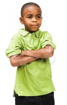 Close-up of a boy standing with his arms crossed isolated over white