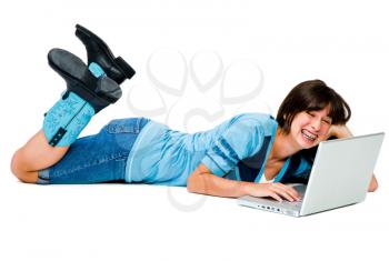 Happy teenage girl using a laptop isolated over white