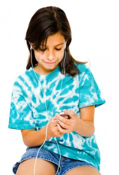 Child listening to music on a MP3 player and smiling isolated over white