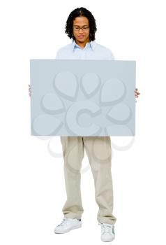 Happy man showing an empty placard isolated over white