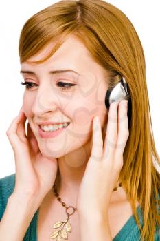Happy woman wearing headphones and listening to music isolated over white