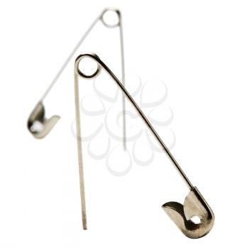 Metal safety pins isolated over white