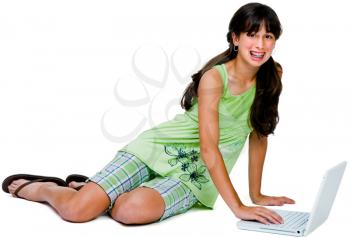 Asian teenage girl using a laptop and smiling isolated over white