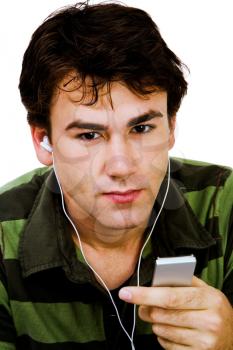 Close-up of a man listening to music on a MP3 player isolated over white