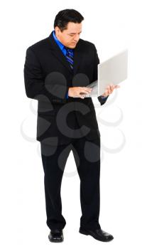 Businessman working on a laptop isolated over white