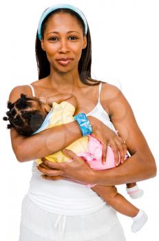 Mid adult woman carrying her daughter and smiling isolated over white