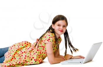 Child using a laptop and smiling isolated over white