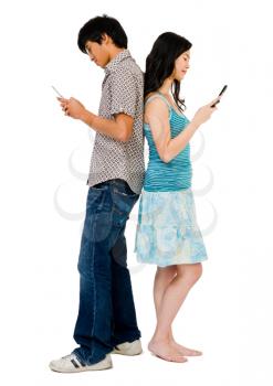 Boyfriend and girlfriend text messaging on mobile phones isolated over white