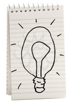 Light bulb sketch on a spiral notebook isolated over white
