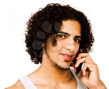 Latin American man talking on a mobile phone isolated over white