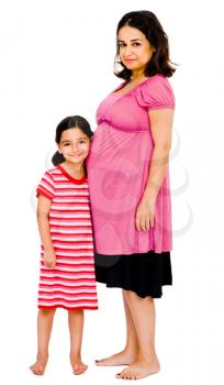 Pregnant woman hugging her daughter and smiling isolated over white