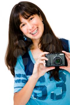 Close-up of a teenager photographing with a camera and smiling isolated over white