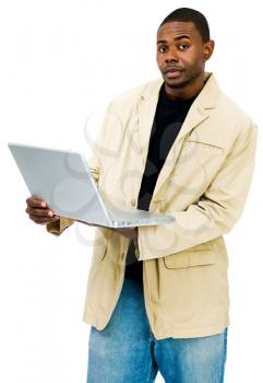 Portrait of a man using a laptop and posing isolated over white
