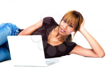 Woman lying on the floor and working on a laptop isolated over white
