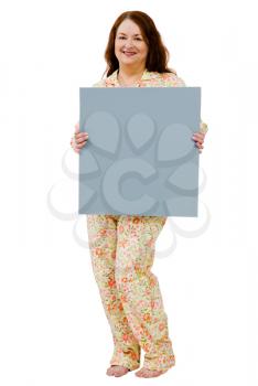 Happy mature woman showing a placard isolated over white