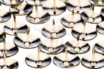 Rows of thumbtacks isolated over white