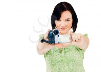 Happy woman holding a home video camera isolated over white