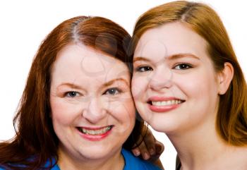 Close-up of two women smiling together isolated over white