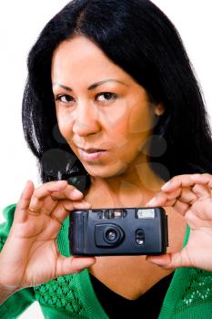 Portrait of a mid adult woman photographing with a camera isolated over white