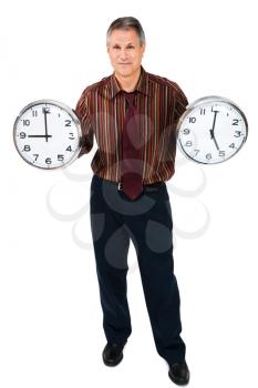Portrait of a businessman holding two clocks isolated over white