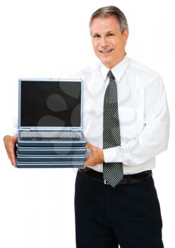 Businessman holding a stack of laptops isolated over white