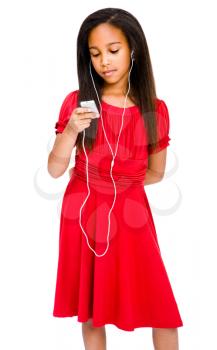 Girl listening to music on a MP3 player and posing isolated over white