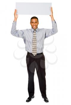 Happy businessman showing a blank placard isolated over white