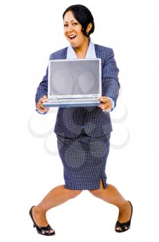 Smiling businesswoman holding a laptop and posing isolated over white