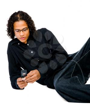 Mixedrace man text messaging on a mobile phone isolated over white