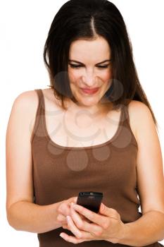 Smiling woman text messaging on a mobile phone isolated over white