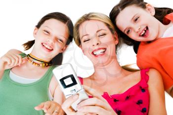 Mother lying with her daughters and photo messaging isolated over white