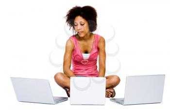 African American woman using laptops and looking busy isolated over white