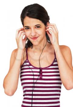 Confident woman listening to music on earbud isolated over white